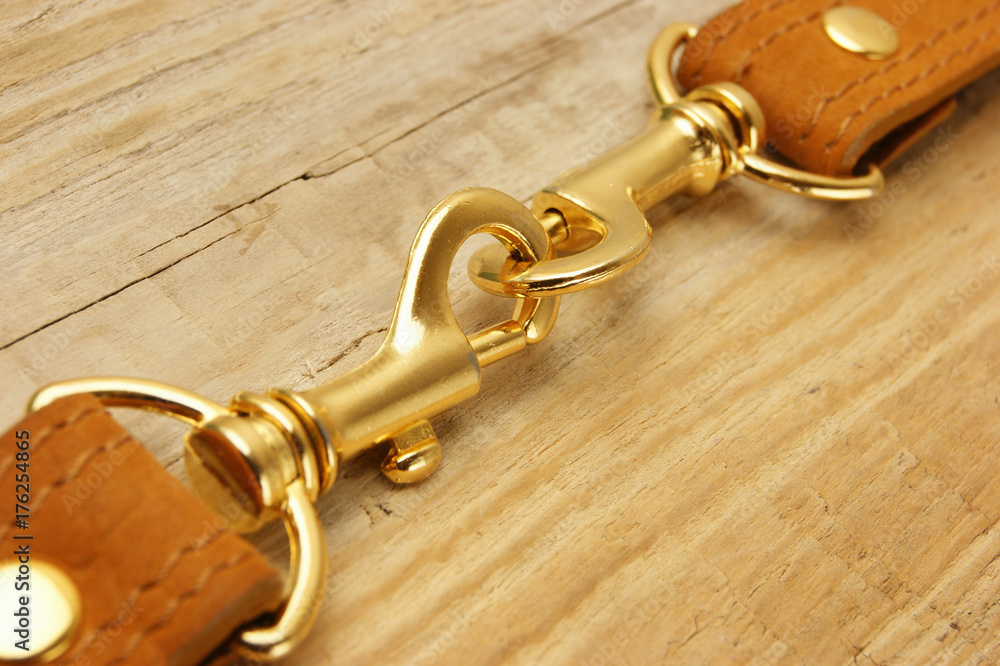 leather strap with carabiner on a wooden board leather strap with carabiner on a wooden board