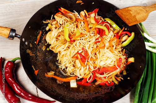 Chinese noodles Udon with vegetables in a frying pan wok