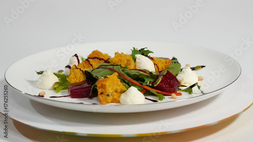 Salad with herring, beetroot, paprika, red onion, mustard and balsamic vinegar. Salad of lettuce, beetroot and salmon fillets with a delicate cream sauce. Salad with greens, fish and beetroot photo