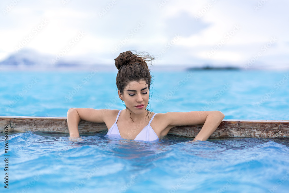 Girl relaxing in geothermal pool outdoors