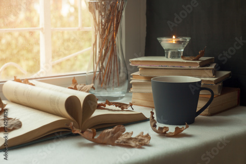 Pages of a book forming the shape of the heart. Passion for reading. hot Cup of tea,a window in the background. Book Heart
