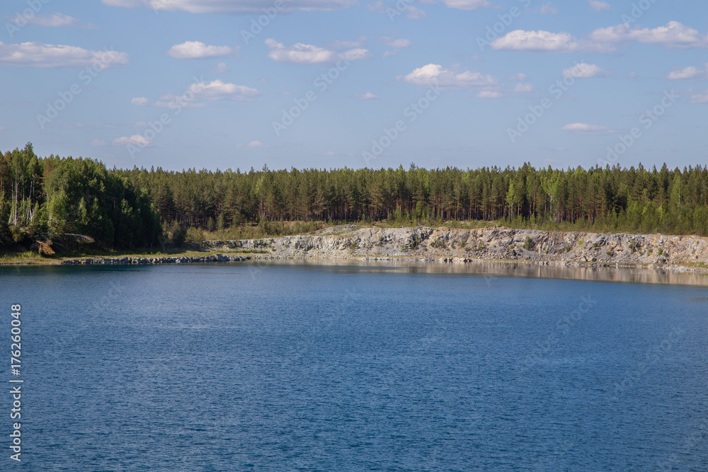 Abandoned flooded open pit quarry mine abestos ore with blue water Abandoned flooded open pit quarry mine abestos ore with blue water