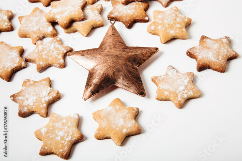 Christmas gingerbread stars with golden metal star.White background.Christmas cookies.
