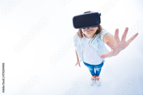 Nice cute girl enjoying being in virtual reality