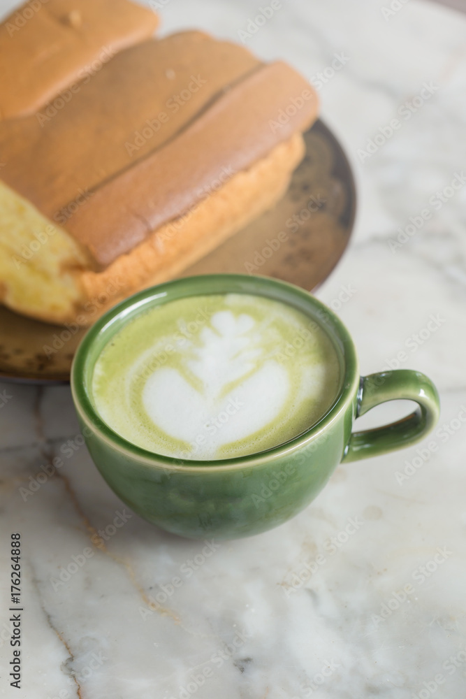 Matcha latte with butter cake breakfast on the marble background Matcha latte with butter cake breakfast on the marble background