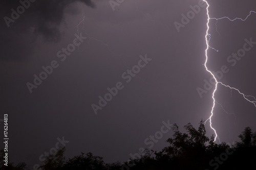 Huge fork lightnings and thunder during heavy summer storm.
