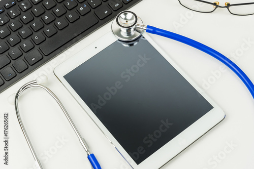 Top view of white tablet pc and doctor tools on the table, Top view of medical equipment, stethoscope, Helthcare and healthy concept.