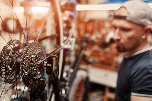 Mechanic repairing bicycle in his workshop