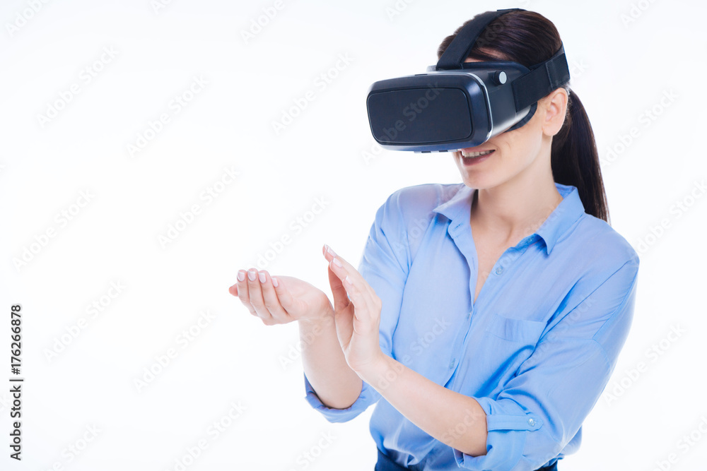 Delighted positive woman looking at her hands Delighted positive woman looking at her hands