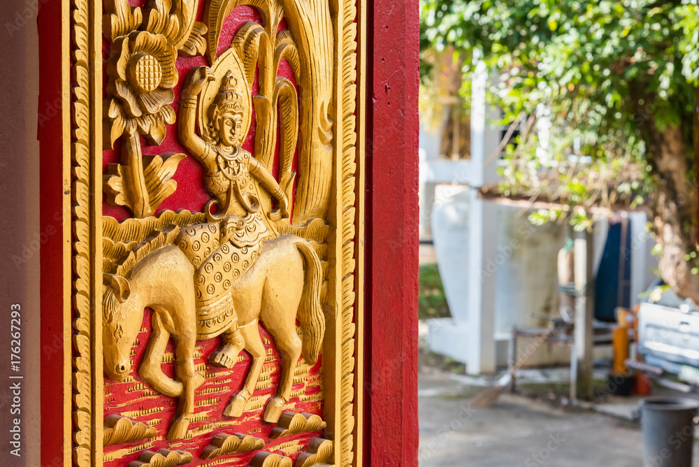 Fototapeta premium Buddhist carvings on the windows of the church in Rongngae temple at Nan Province, Thailand.