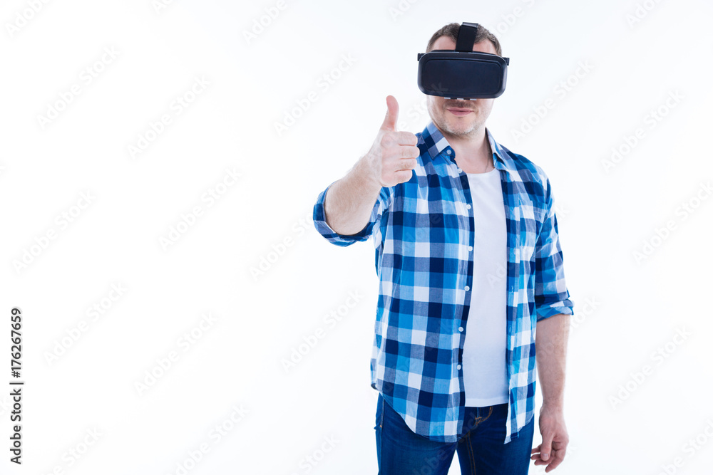 Handsome positive man showing thumbs up gesture Handsome positive man showing thumbs up gesture