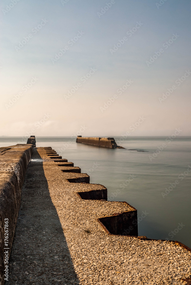 Long exposure of destroyed pier in foggy morning