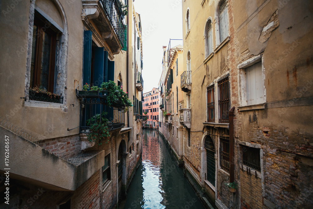 Water runs in the canel between houses in Venice