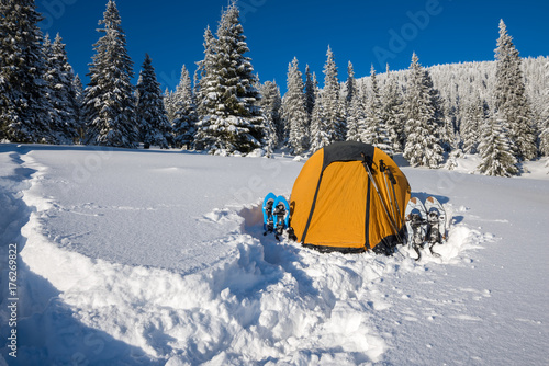 Yellow tent and snowshoes in a deep snow © sanechka