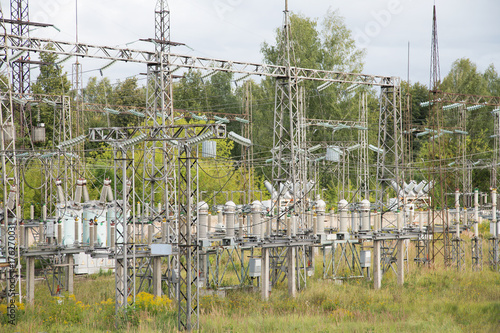 Electrical substation poles and wires summer day