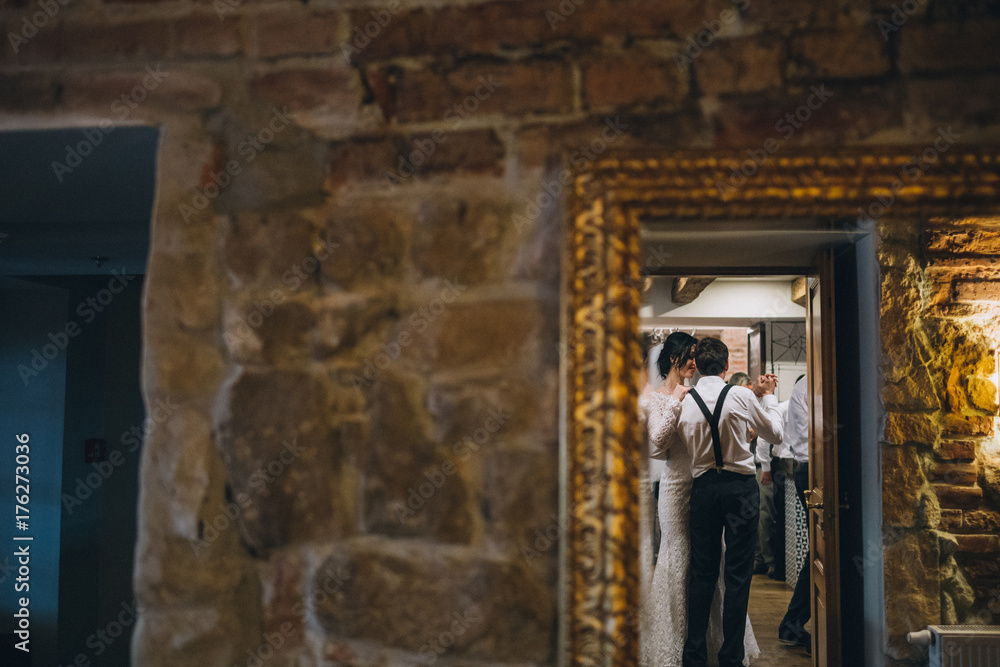 Reflection of smiling wedding couple dancing in the room Reflection of smiling wedding couple dancing in the room
