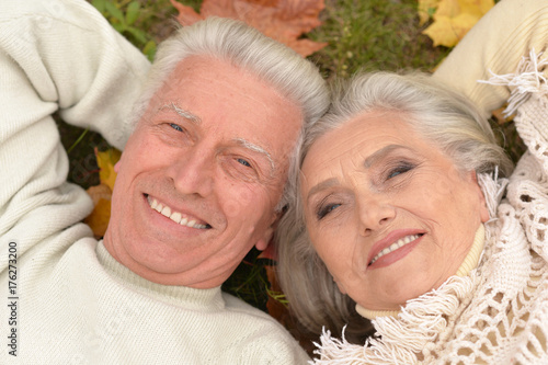 couple in autumn park lying