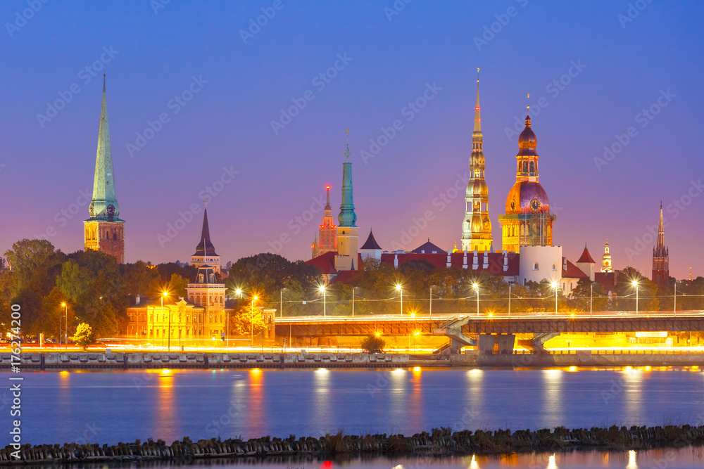 Old Town of Riga and River Daugava at night, Riga Cathedral, Saint Peter church, Cathedral Basilica of Saint James and Riga castle in the background, Latvia