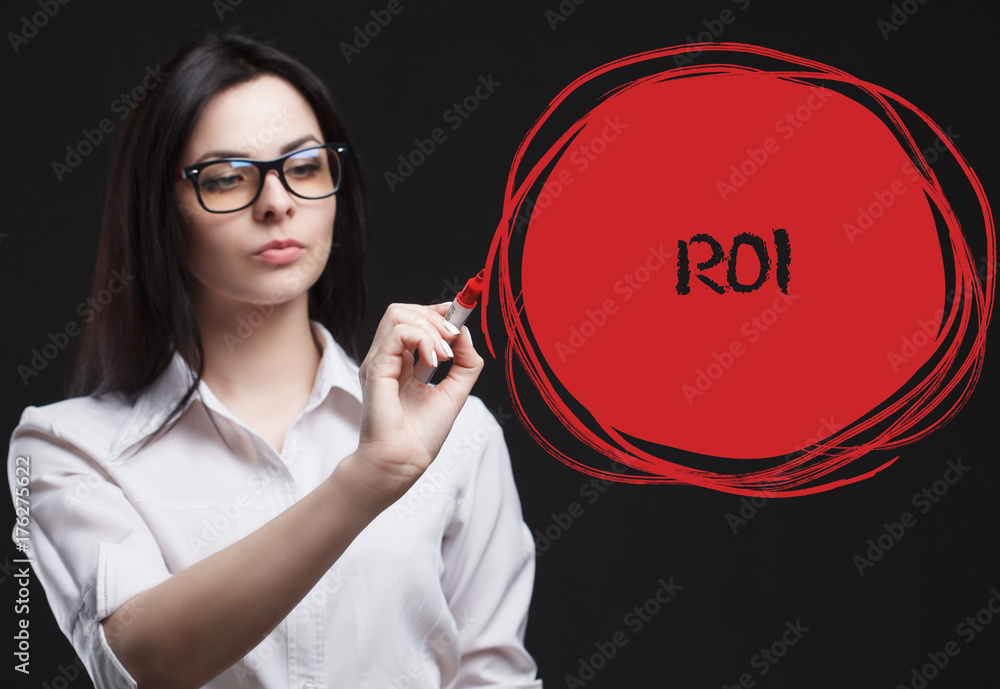 The concept of marketing, technology, the Internet and the network. A young businessman shows what is important for business: ROI The concept of marketing, technology, the Internet and the network. A young businessman shows what is important for business: ROI