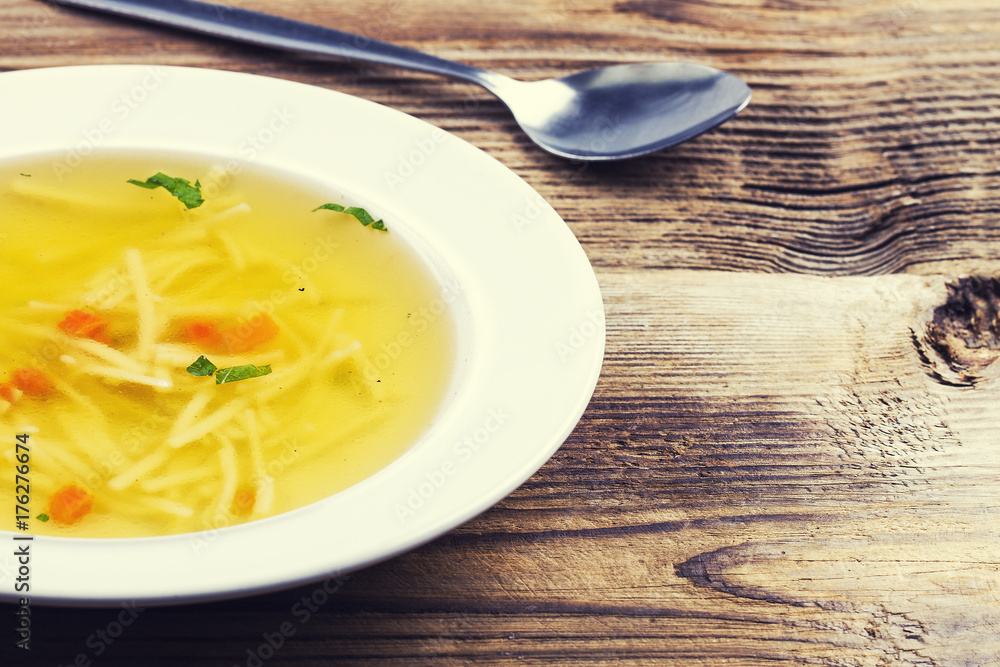 Chicken soup in a white ceramic soup plate Chicken soup in a white ceramic soup plate