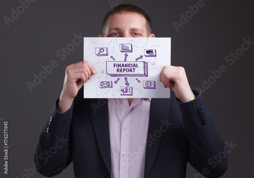 The concept of business, technology, the Internet and the network. Young businessman showing inscription: Financial report