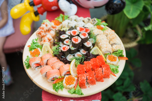 Close-up of different sushi on a tray outdoors