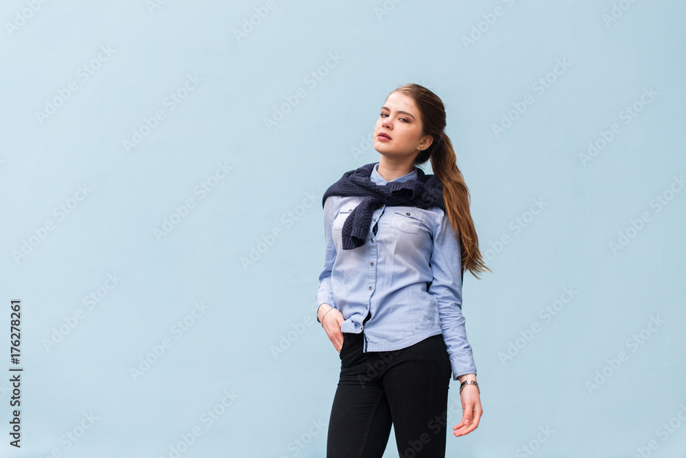 Very beautiful girl on a background of blue wall Very beautiful girl on a background of blue wall