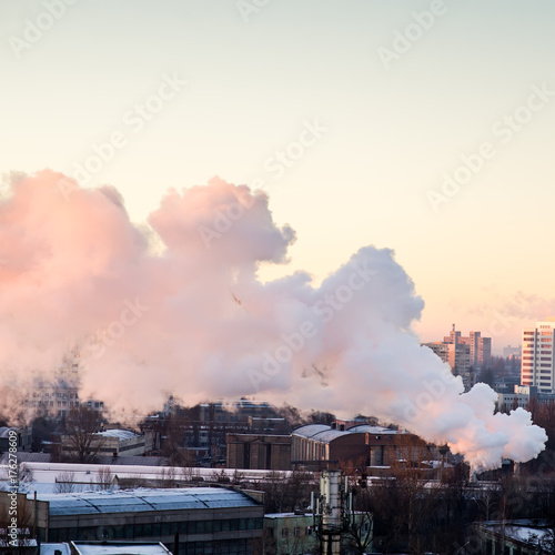 Smoking industrial chimneys at dawn. Concept for environmental protection