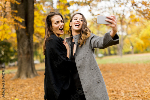 Two young women taking self...