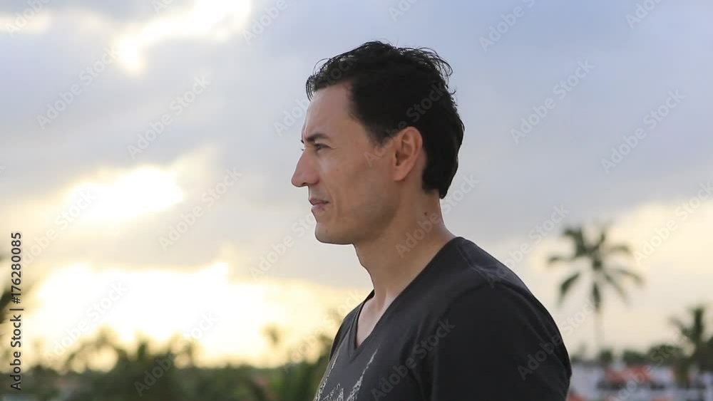 The Mexican man looks around, searching, smiling The Mexican man looks around, searching, smiling