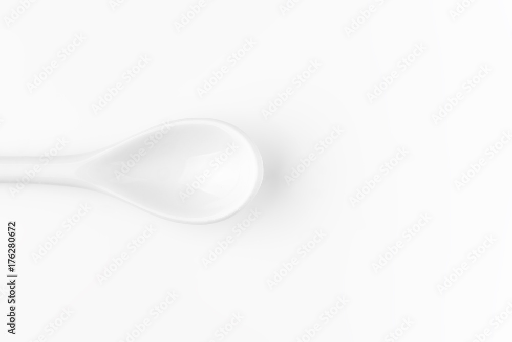 White spoon isolated on a white surface White spoon isolated on a white surface