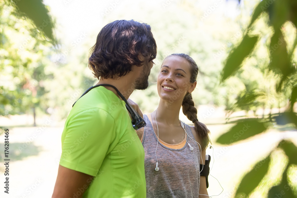 Fototapeta premium Smiling couple stretching outdoors
