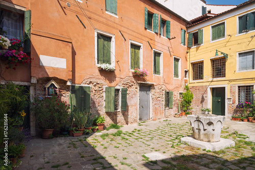 Small, cozy courtyard with colorful cottage /  Venice  in Italy / The small yard with bright walls of houses © Rochu_2008