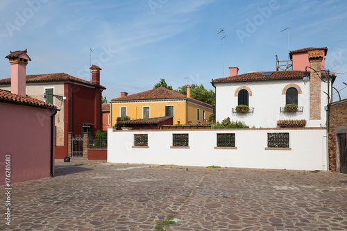 Small, cozy courtyard with colorful cottage / The small yard with bright walls of houses