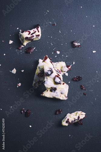 Smashed white chocolate on black photo