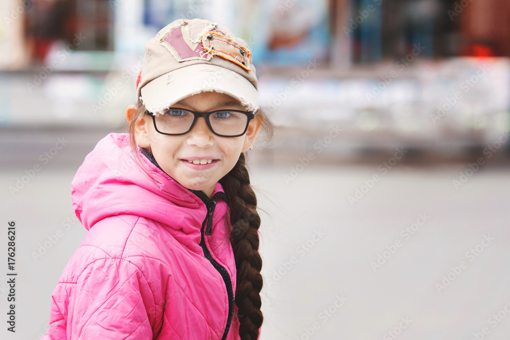 little girl in a pink jacket and glasses little girl in a pink jacket and glasses