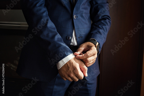 Businessman wears a jacket.Politician, man's style,male hands closeup, American, European businessman, business, fashion and clothing concept © bondvit