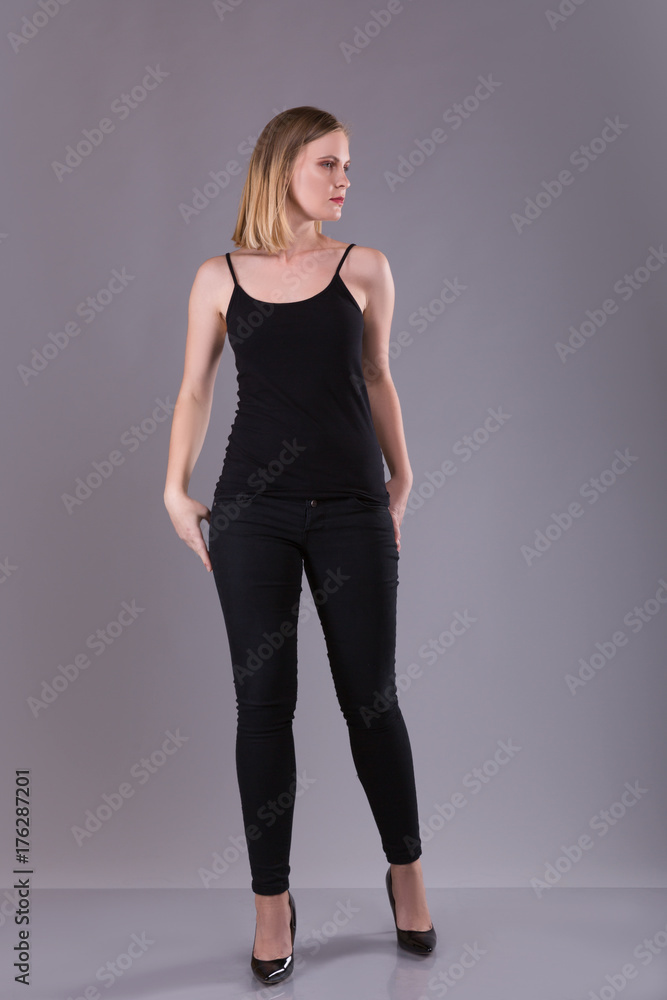 Blonde woman in bkack suit on gray background Blonde woman in bkack suit on gray background
