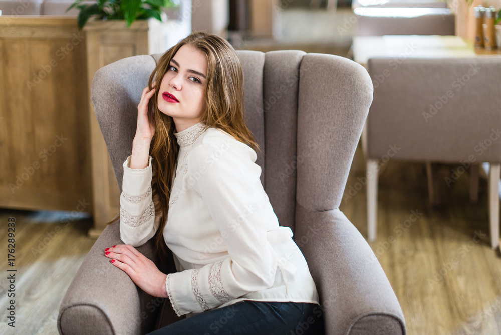 Beautiful young girl with professional makeup and hairstyle sitting in restaurant. Beautiful young girl with professional makeup and hairstyle sitting in restaurant.