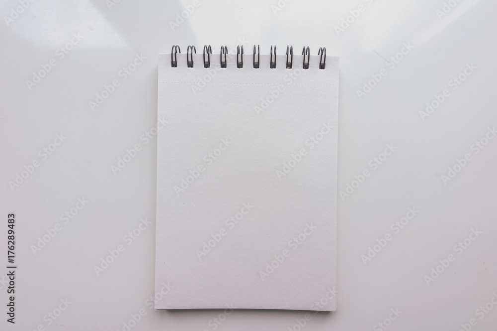 Open Notepad with a blank sheet of paper on a white background. Top view Open Notepad with a blank sheet of paper on a white background. Top view
