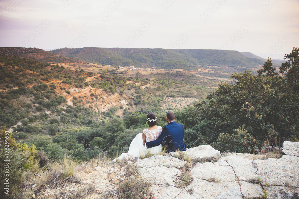 Fototapeta premium Bride and groom embracing in the park