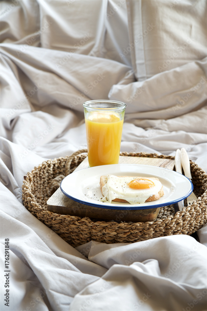 Simple breakfast in bed. Fried eggs with orange juice on tray
Simple breakfast in bed. Fried eggs with orange juice on tray