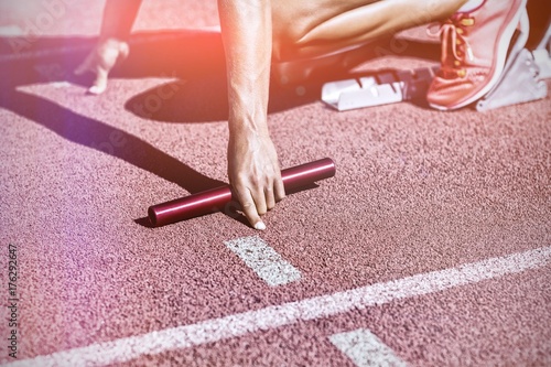 Female athlete ready to start relay race