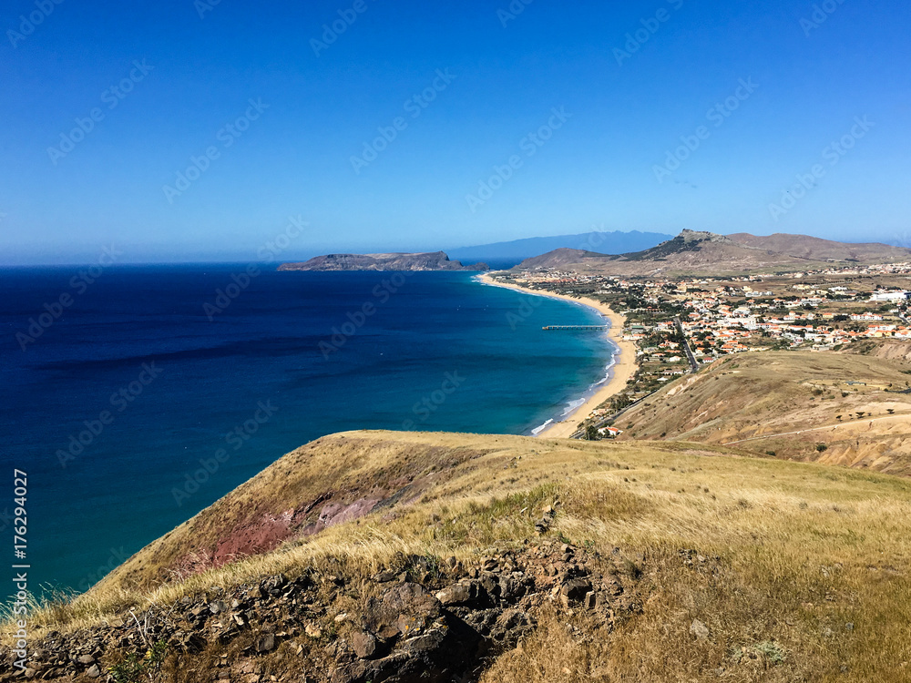 The landscape view of the beach at Porto Santo with the shadow of Madeira in the background