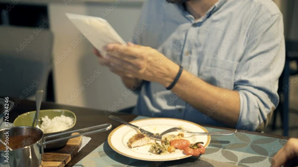 Young couple talking and looking at tablet computer during dinner
Young couple talking and looking at tablet computer during dinner