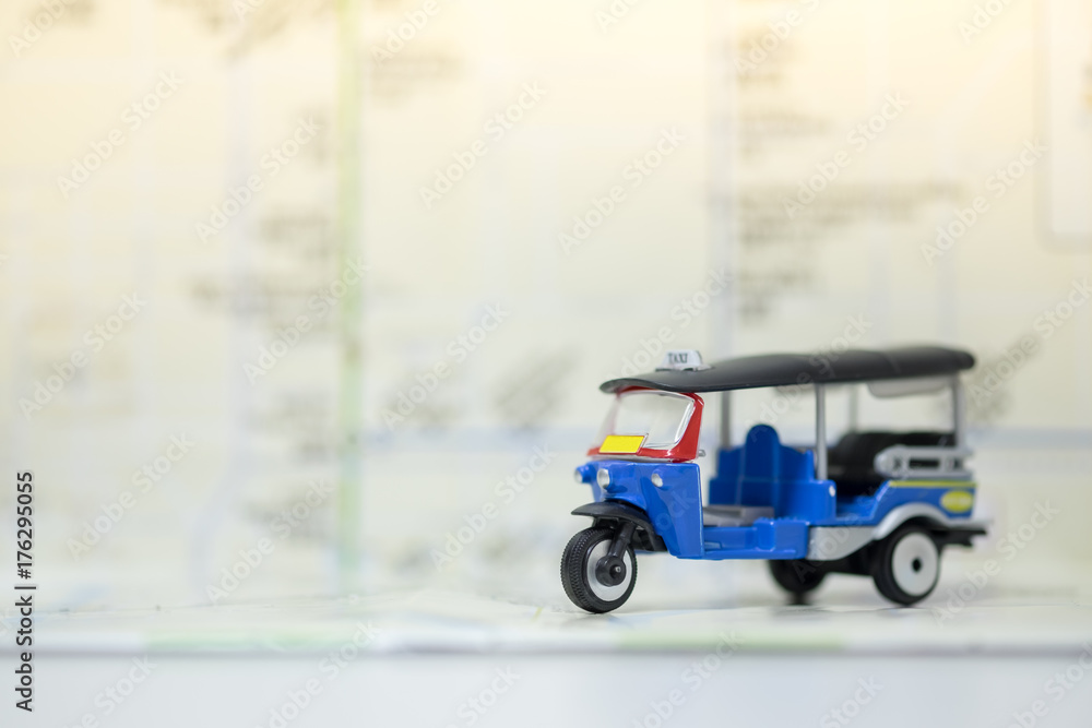 Travel Concept. Thailand three wheel car (as called Tuk-Tuk) toy on route map.