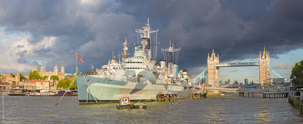 LONDON, GREAT BRITAIN - SEPTEMBER 13, 2017: The panorama of the Tower bridge and cruiser Belfast in evening light with the dramatic storm clouds.