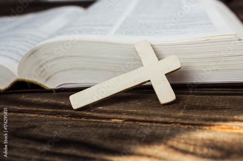 bible and cross on wooden background