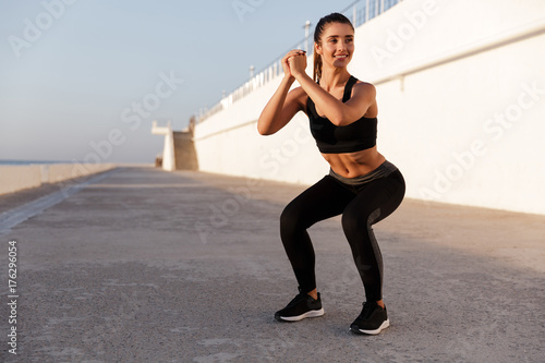 Young beautiful caucasian lady making sits-up exercise © Drobot Dean