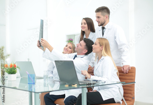 group of doctors discussing an x-ray ,sitting at the table.